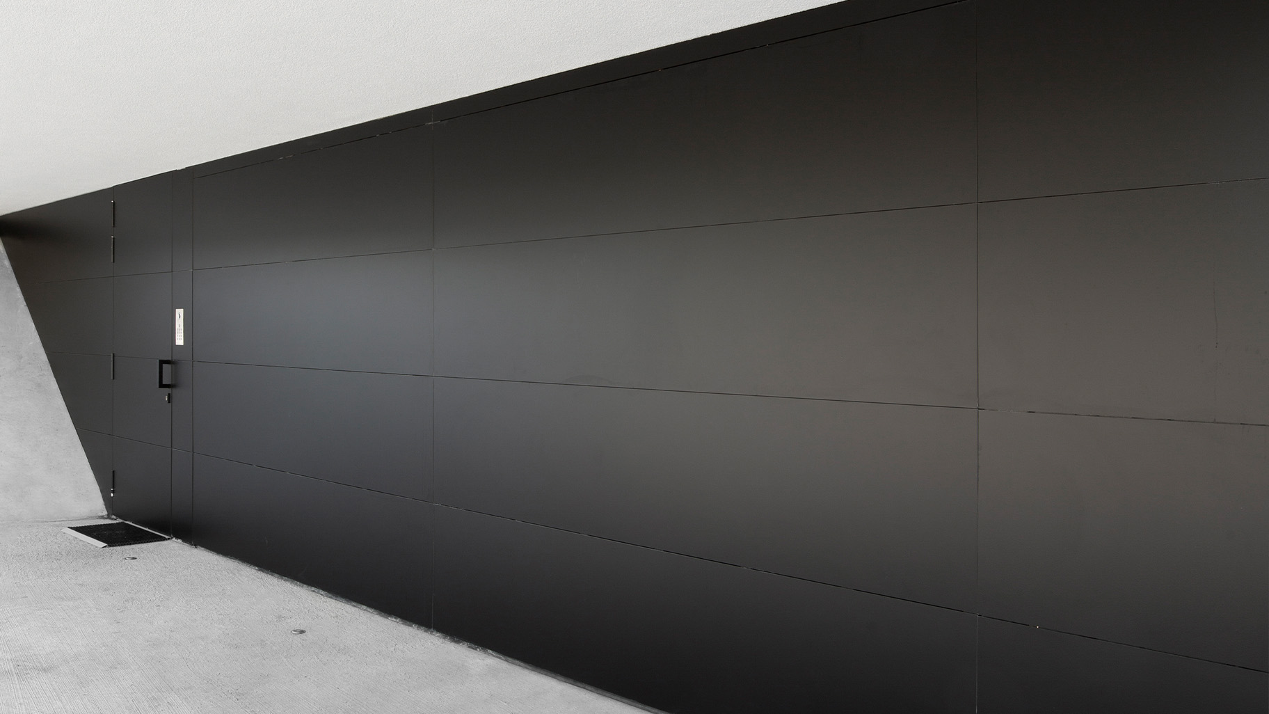 Matt zwarte Trespa plaat in garagedeur in moderne villa