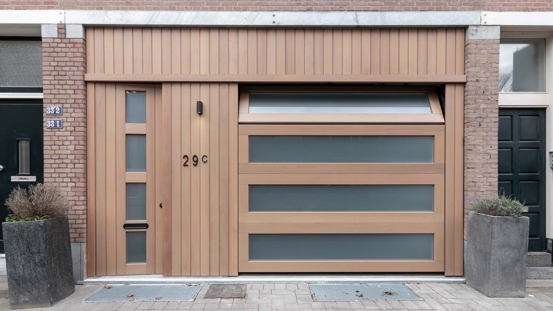 Houten garagedeur met voordeur in Iroko hout met HR++ melkglas